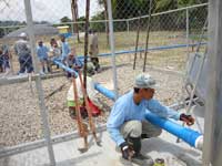 Trainees provide hands-on assistance in installing gas pipes at Biotech in the Philippines.