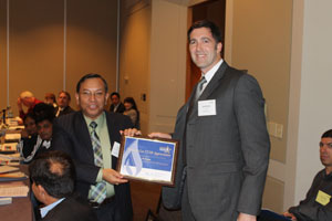 Scott Bartos (U.S. EPA's Natural Gas STAR Program) giving A.K. Hazarika (India's Oil and Natural Gas Corporation Ltd) a certificate of appreciation at the GMI Oil & Gas Subcommittee meeting.